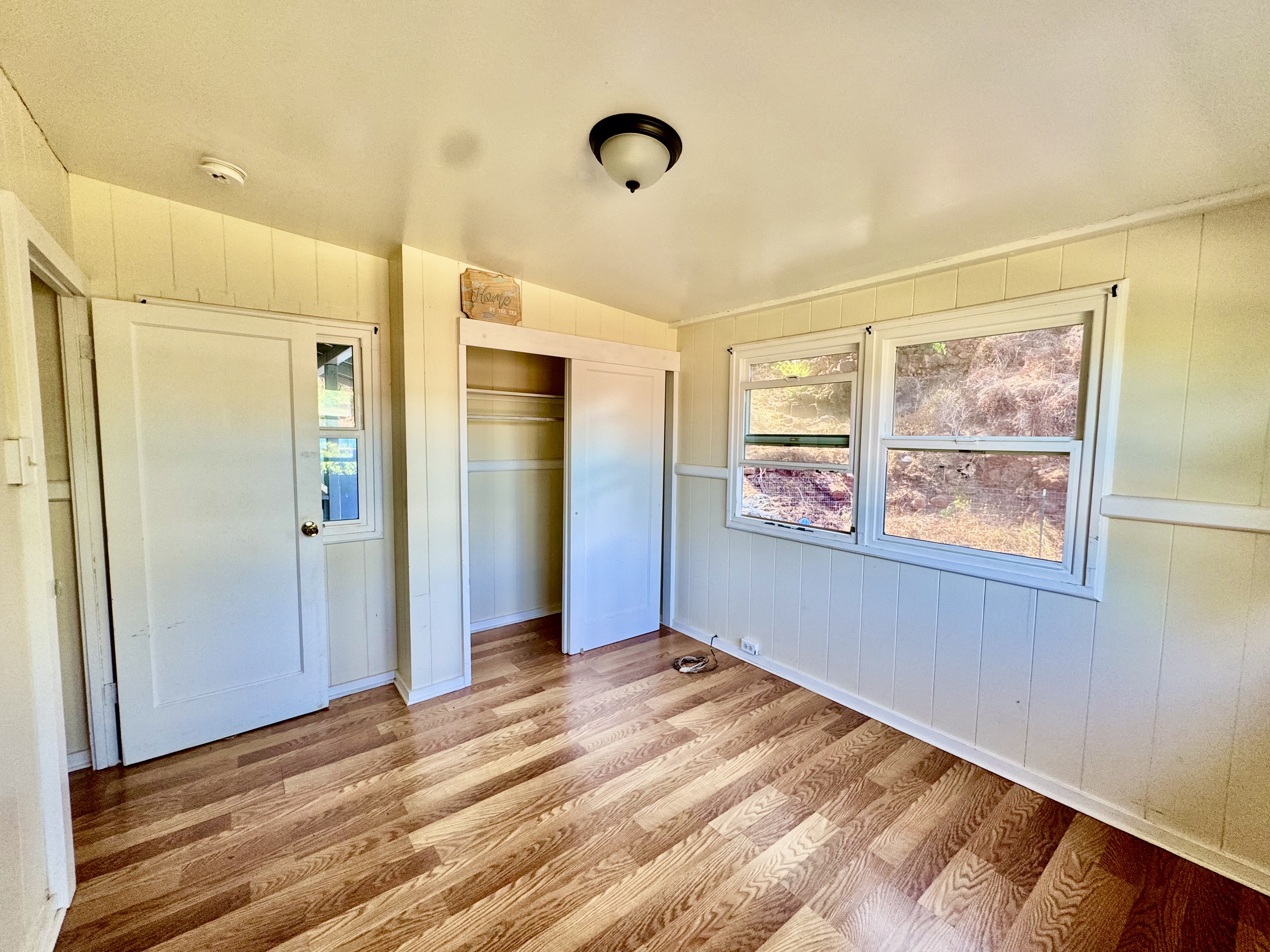 4611 Menehune Road, Unit 2 Waimea, HI 96796 - Photo 15 of 25 a view of an empty room with window and wooden floor