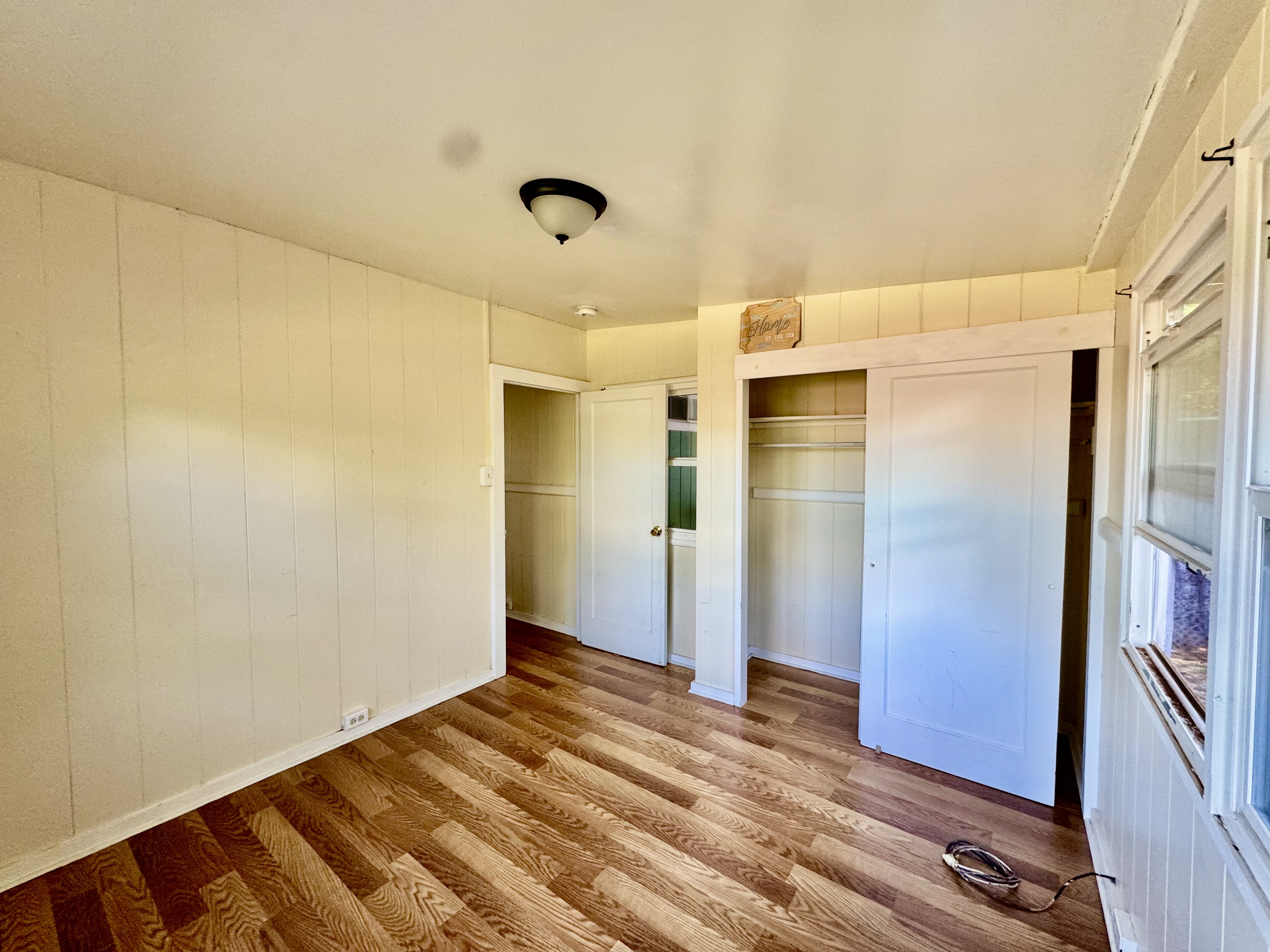 4611 Menehune Road, Unit 2 Waimea, HI 96796 - Photo 17 of 25 a view of empty room with wooden floor and fan