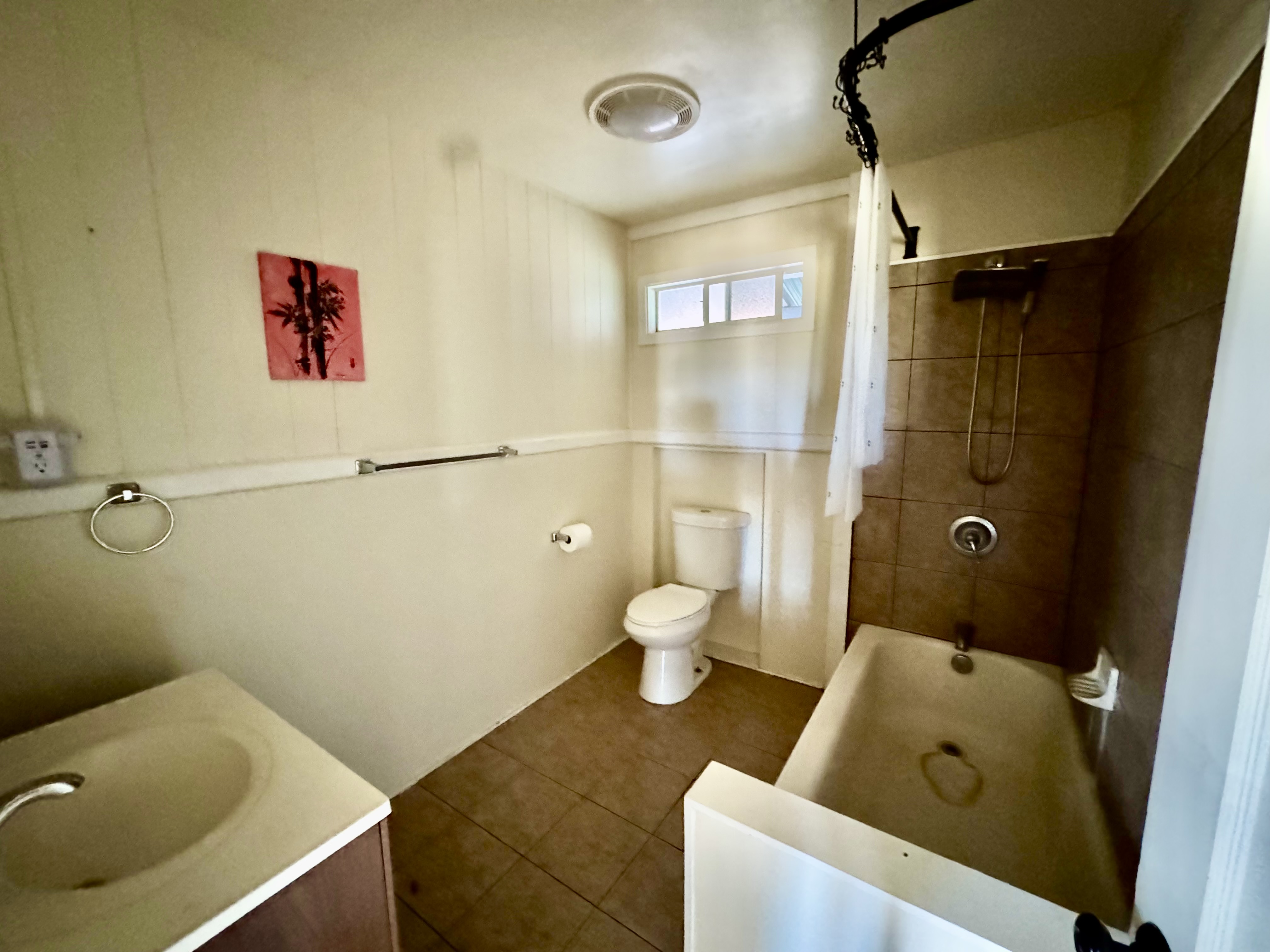 4611 Menehune Road, Unit 2 Waimea, HI 96796 - Photo 22 of 25 a bathroom with a sink and mirror with toilet