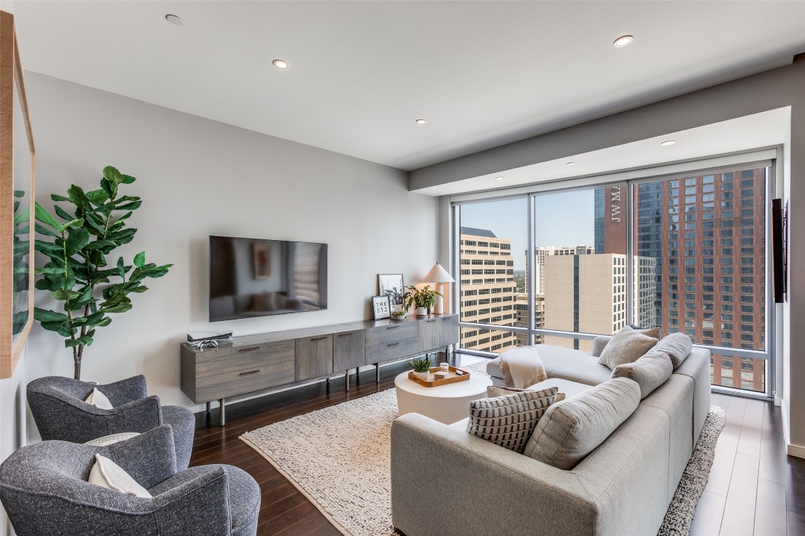 200 Congress Avenue, Unit 23B Austin, TX 78701 - Photo 1 of 9 a living room with furniture and a flat screen tv