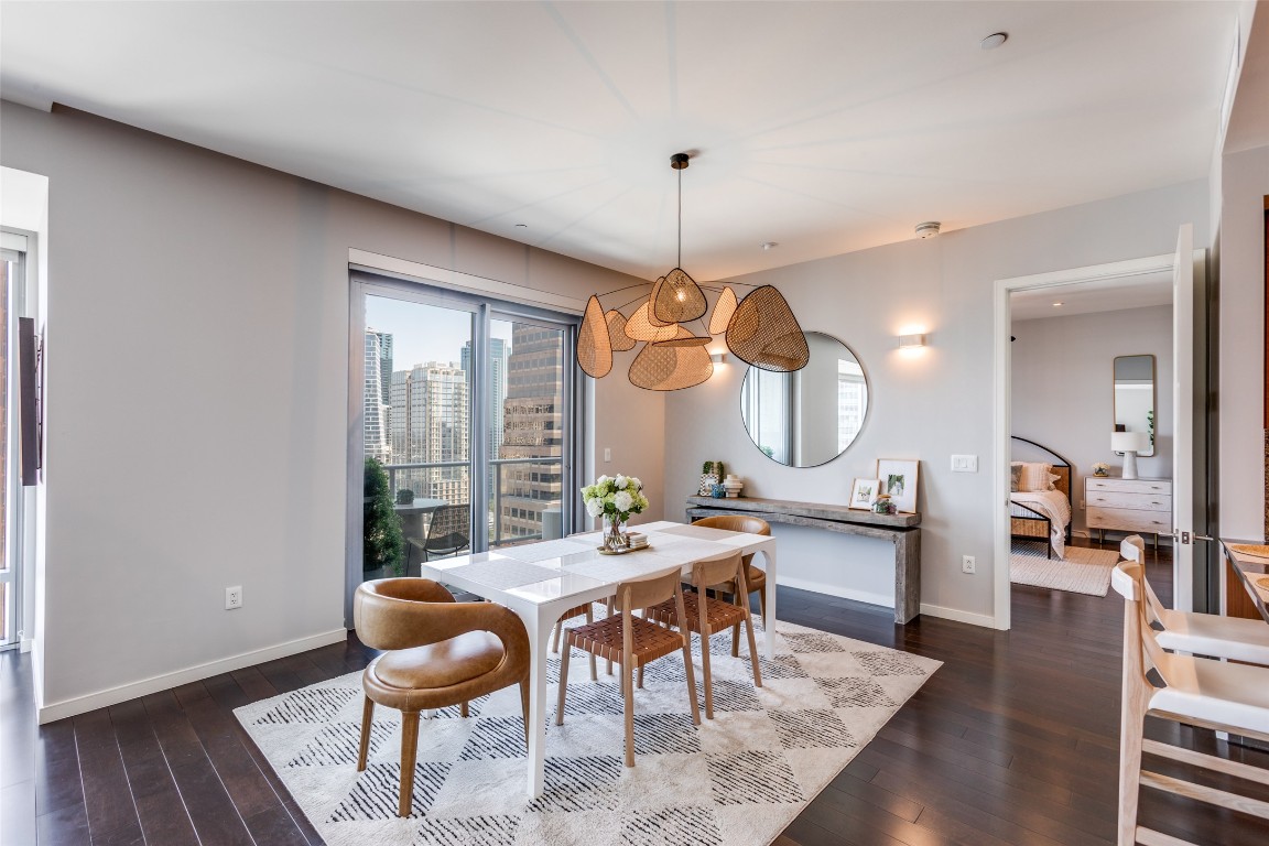 200 Congress Avenue, Unit 23B Austin, TX 78701 - Photo 3 of 9 a view of a dining room with furniture window and wooden floor