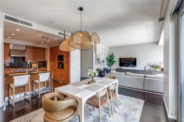 a kitchen with stainless steel appliances granite countertop a sink a stove and chairs