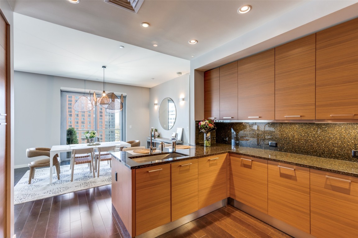200 Congress Avenue, Unit 23B Austin, TX 78701 - Photo 6 of 9 a open kitchen with stainless steel appliances granite countertop a sink and cabinets