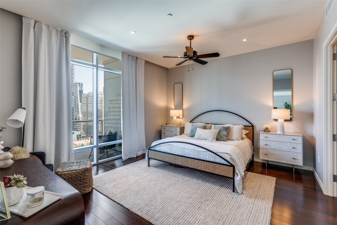 200 Congress Avenue, Unit 23B Austin, TX 78701 - Photo 7 of 9 a bedroom with a bed couch and a window