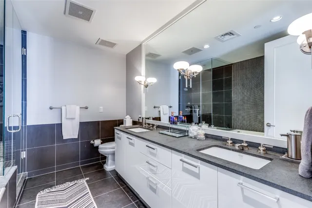 a bathroom with a double vanity sink mirror and double