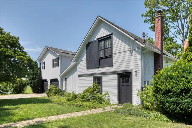 a front view of house with a garden