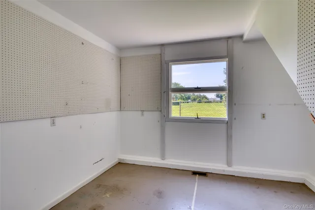 a view of room with ceiling fan and windows