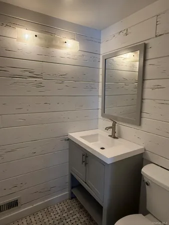 a view of room with ceiling fan and windows