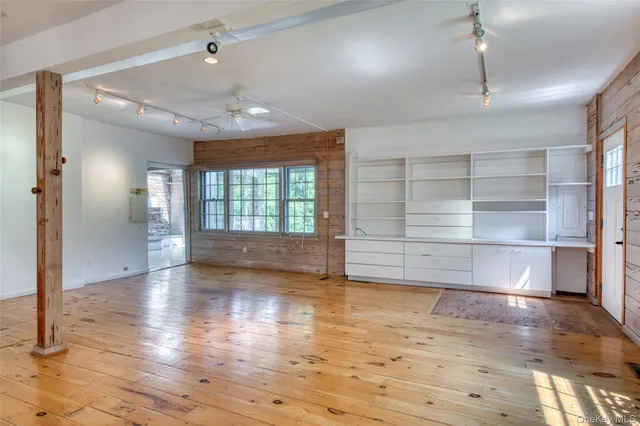 a view of empty room with wooden floor