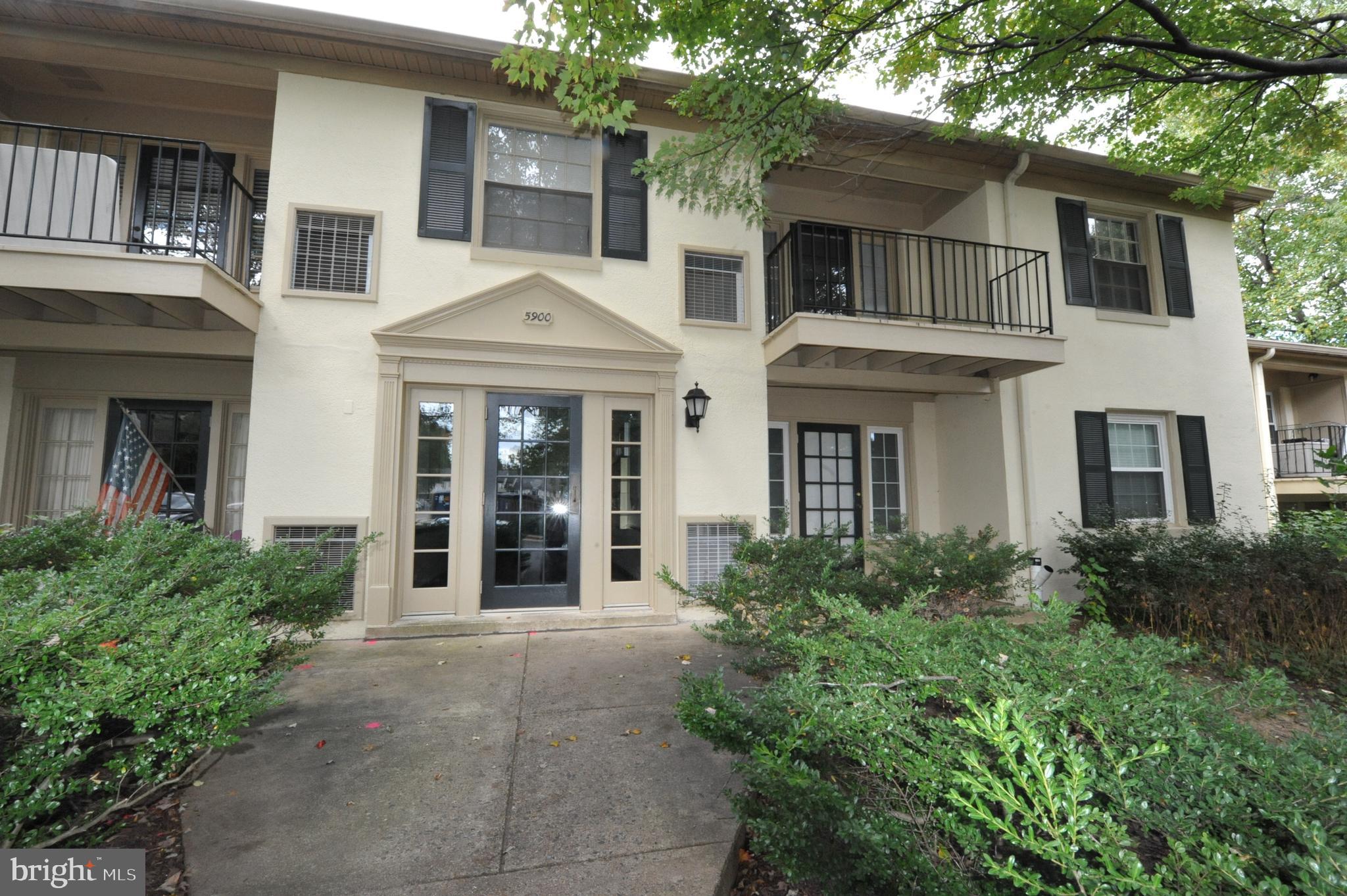 5900 K Surrey Hill Place, Unit 697 Springfield, VA 22152 - Photo 18 of 32 front view of a brick house with a yard