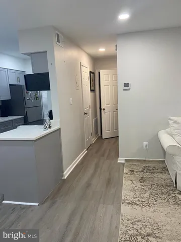 a view of a kitchen with a sink and a refrigerator