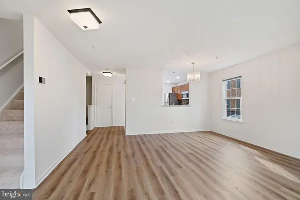a view of a big room with wooden floor and windows