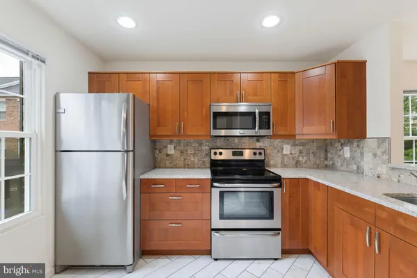 a kitchen with a refrigerator sink and microwave