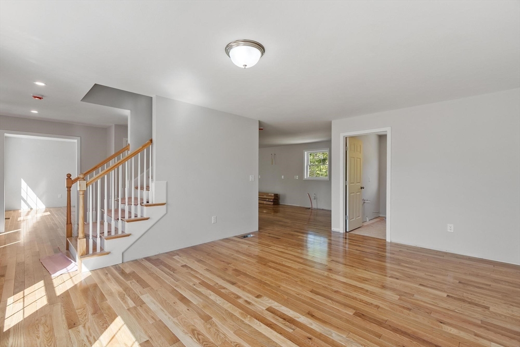 22 Benoit Avenue Pelham, NH 03076 - Photo 24 of 42 a view of an empty room with wooden floor and a lamp