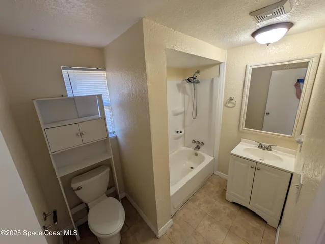 a bathroom with a sink a toilet and bathtub