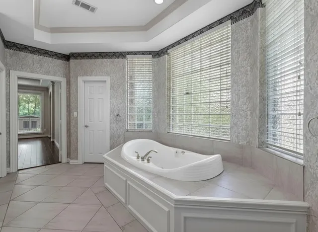 a bathroom with a bathtub and shower