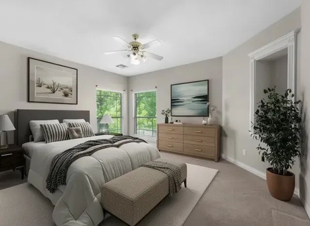 a spacious bedroom with a bed and a window