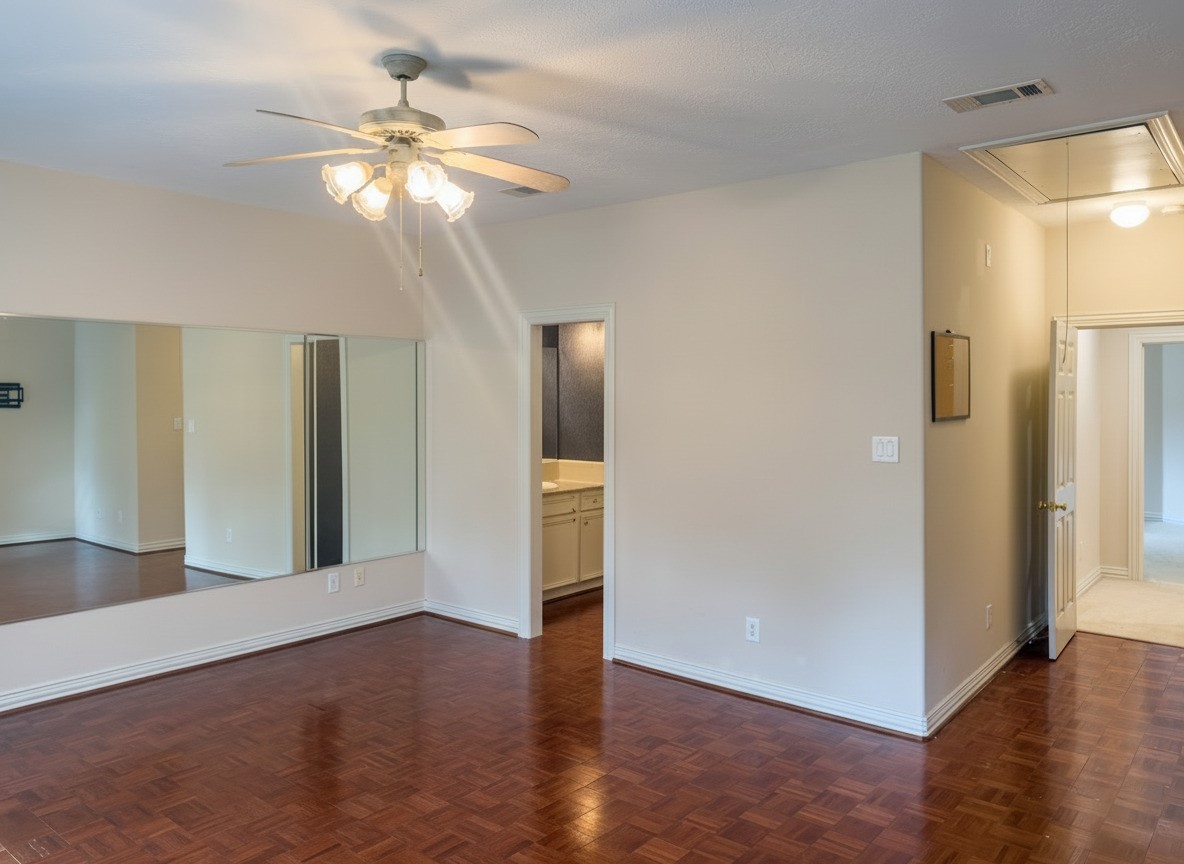 3311 El Dorado Boulevard Missouri City, TX 77459 - Photo 21 of 29 a view of an empty room with wooden floor and a ceiling fan
