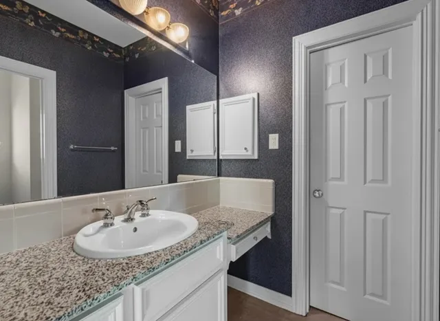 a bathroom with a sink and a mirror