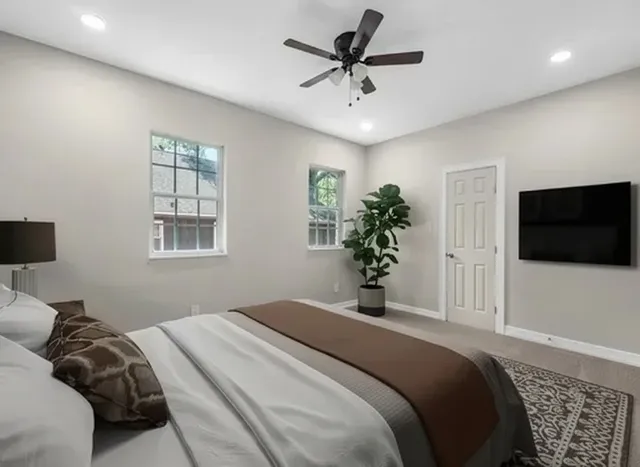 a bedroom with a bed and a flat screen tv