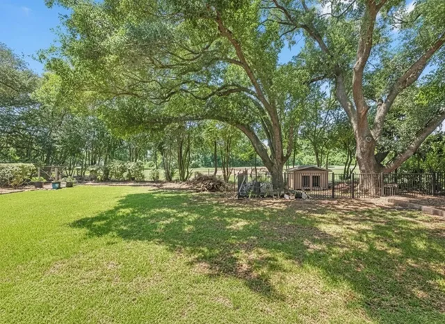 a view of a house with backyard and sitting area