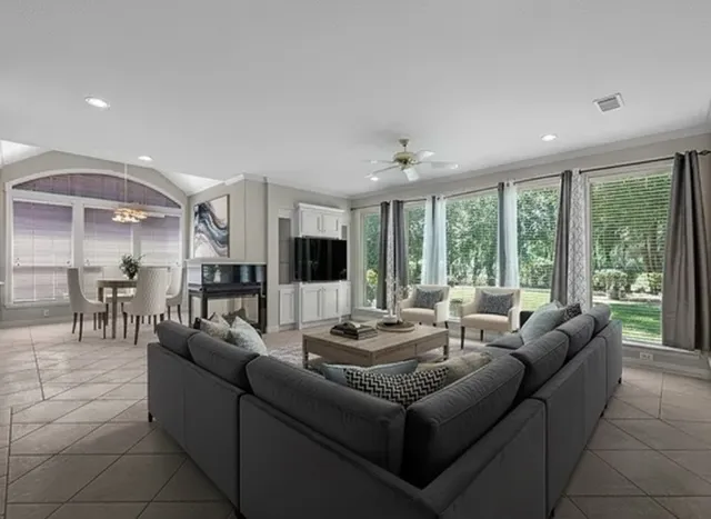 a living room with furniture and a large window