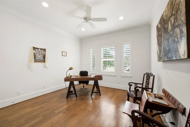 a view of a workspace with furniture and a window