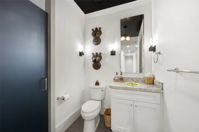 a bathroom with a granite countertop sink a toilet and a mirror