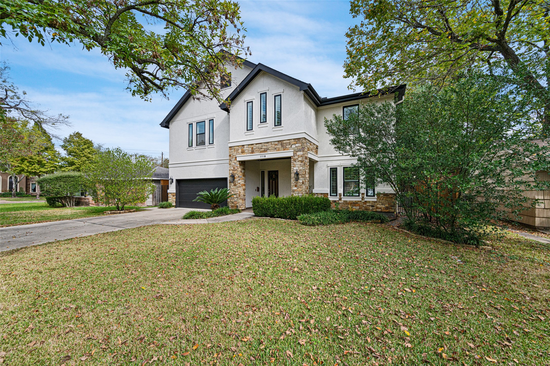 1118 Anderson Street Bellaire, TX 77401 - Photo 2 of 45 a front view of a house with garden