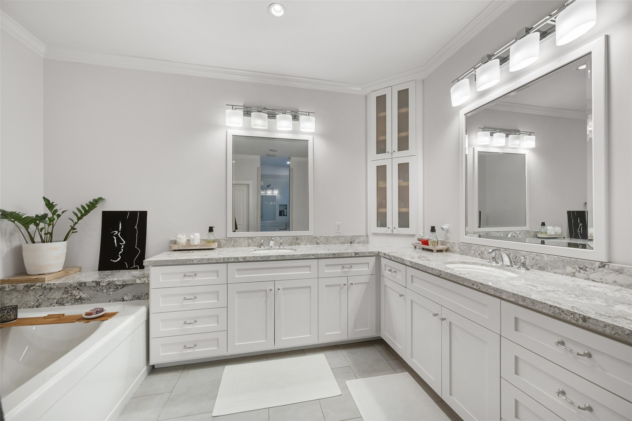 1118 Anderson Street Bellaire, TX 77401 - Photo 25 of 45 a spacious bathroom with a granite countertop sink and a mirror