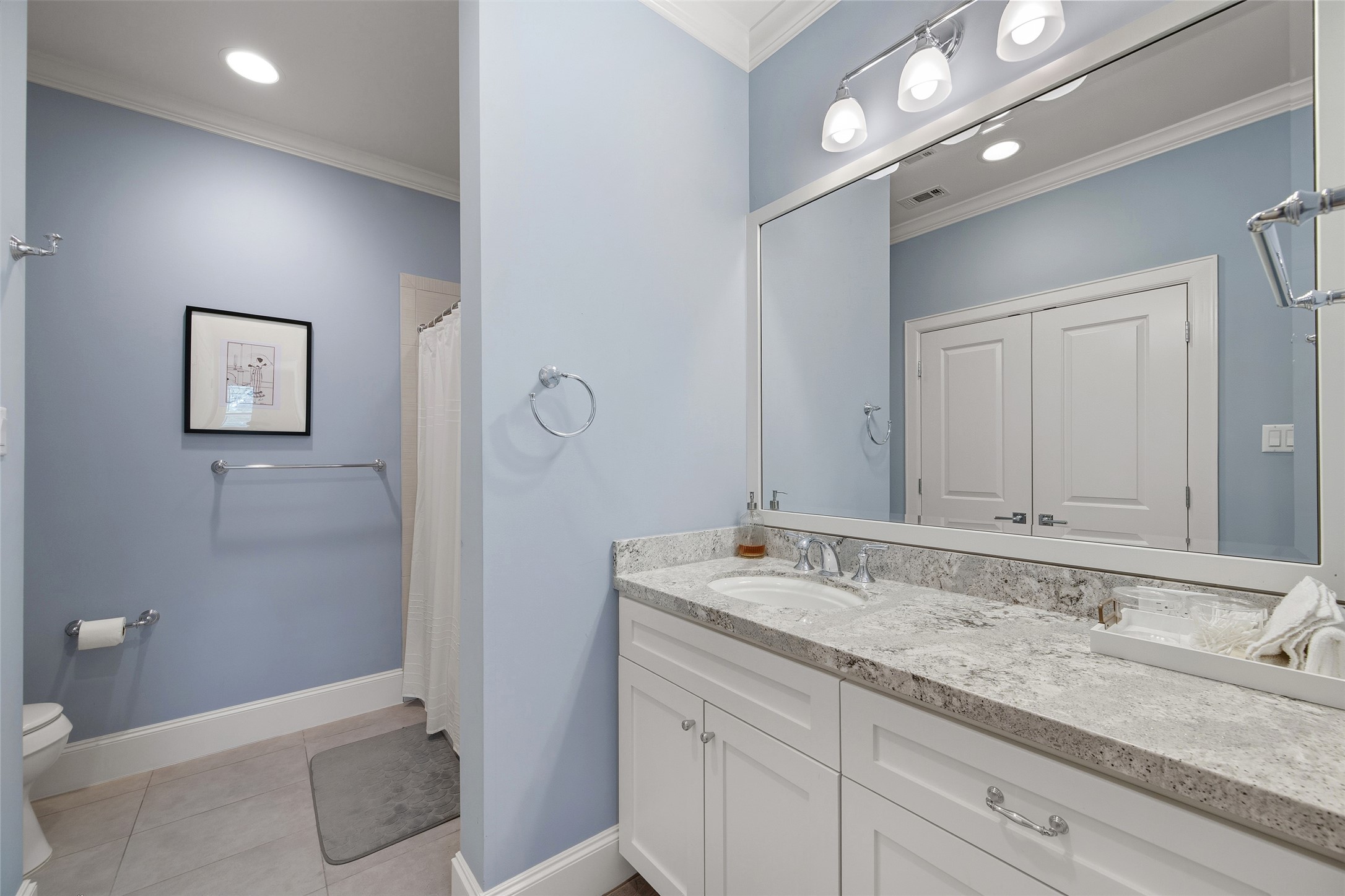 1118 Anderson Street Bellaire, TX 77401 - Photo 31 of 45 a bathroom with a granite countertop sink double vanity and a mirror