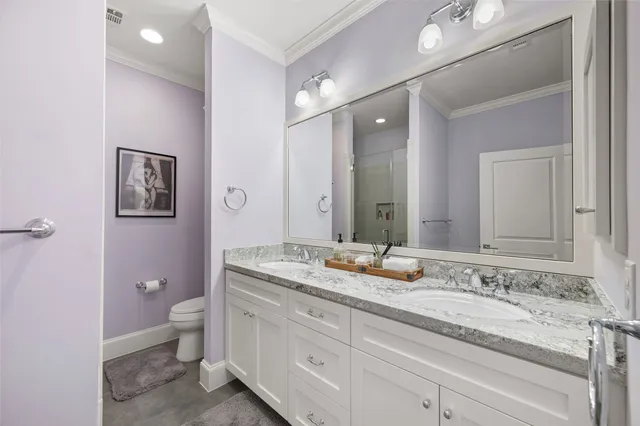 a bathroom with a granite countertop sink mirror and toilet