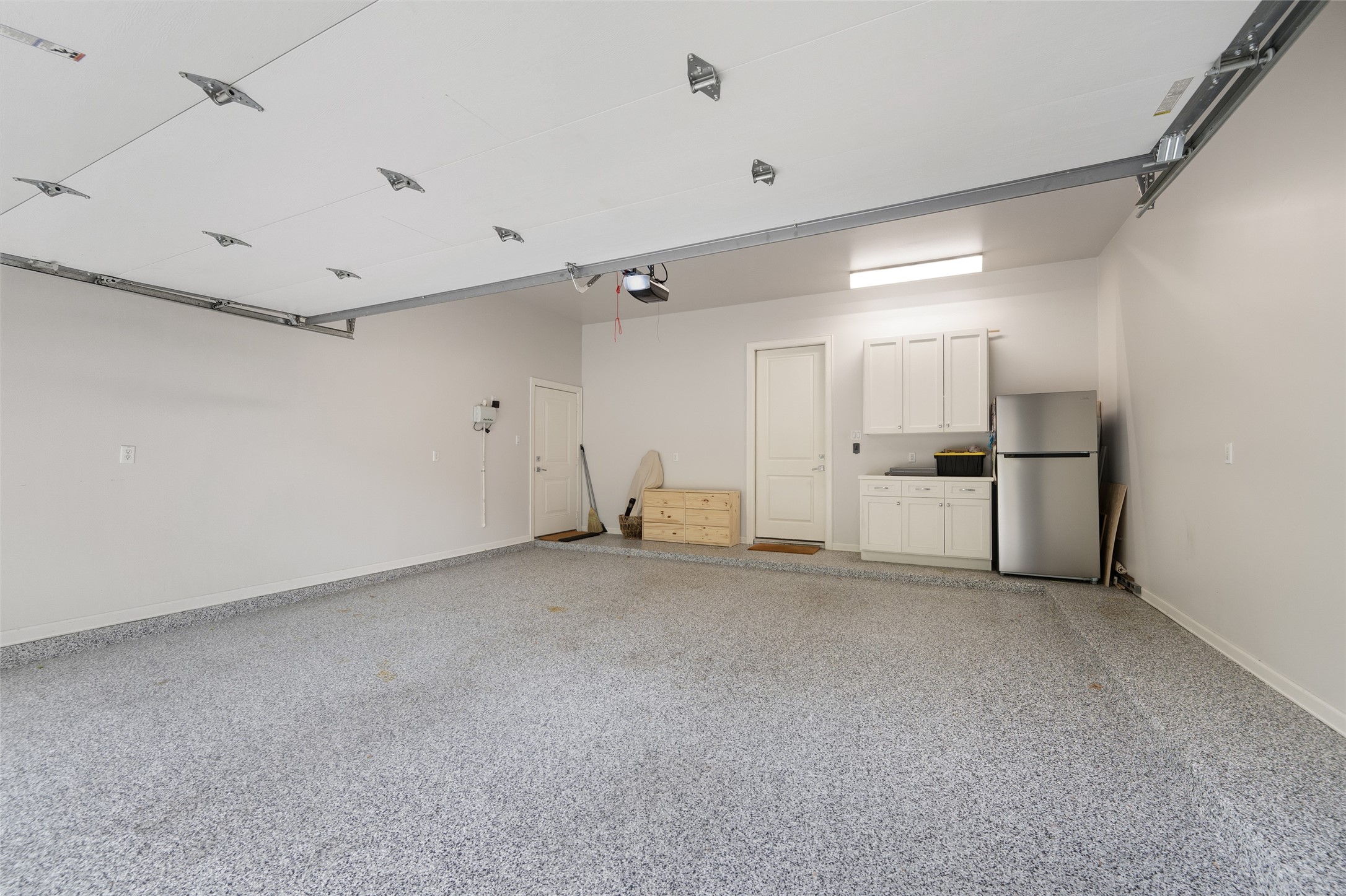 1118 Anderson Street Bellaire, TX 77401 - Photo 36 of 45 a view of a kitchen with a refrigerator and white cabinets