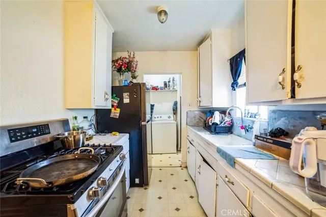 a kitchen with a sink stove and refrigerator