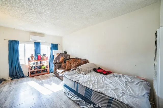 a bed sitting in a bedroom next to a window