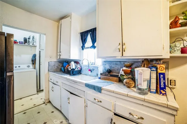 a kitchen with stainless steel appliances cabinets and a window