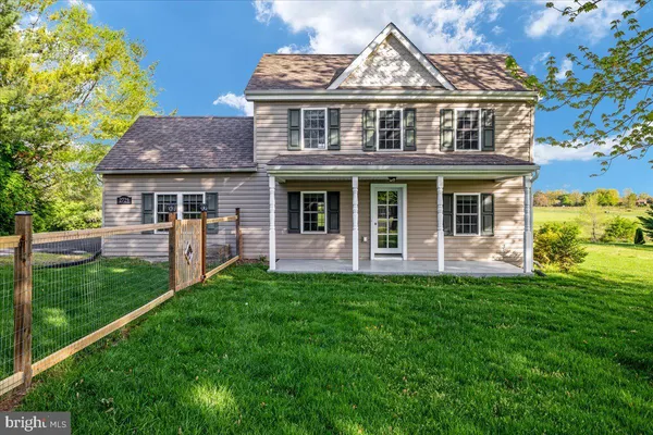 a view of a house with a yard and plants