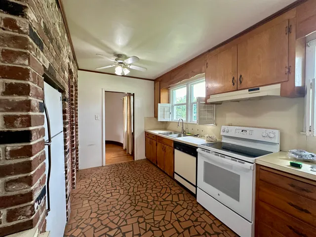 a kitchen with stainless steel appliances granite countertop a sink and cabinets