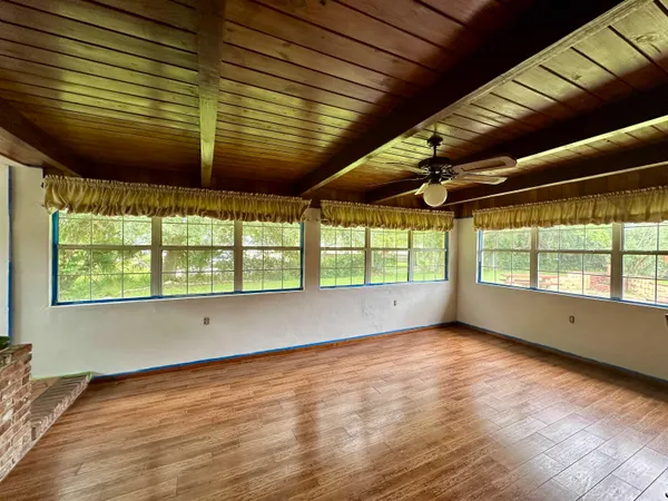 a view of room with wooden floor and roof