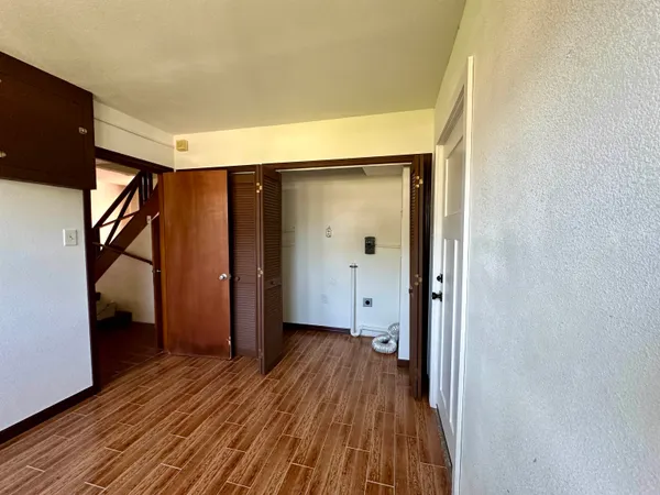 a view of hallway with wooden floor