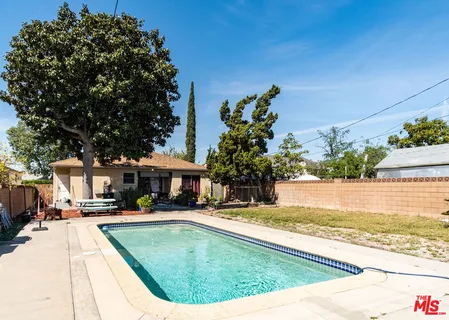 a swimming pool view with a outdoor seating