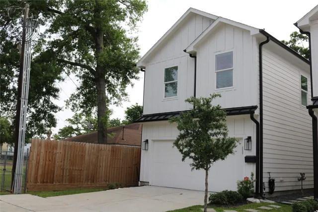 a house that has a tree in front of it