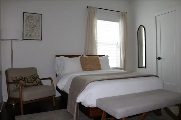 a bedroom with a bed and window