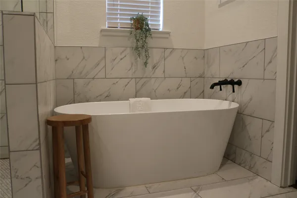 a white bath tub sitting in a bathroom