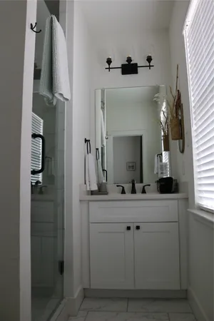 a bathroom with a double vanity sink and mirror