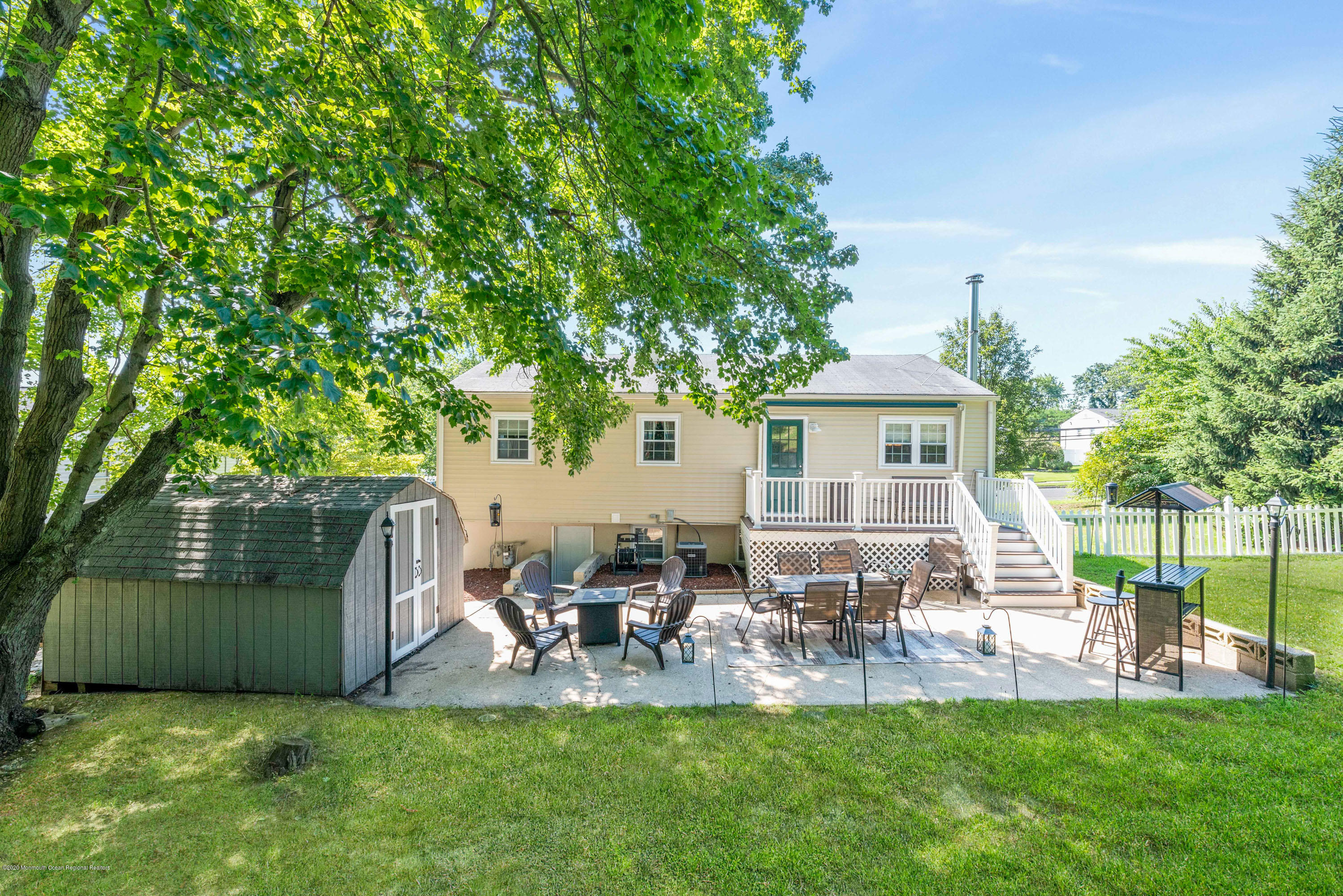 53 Salem Hill Road Howell, NJ 07731 - Photo 27 of 27 a view of a backyard with table and chairs and a large tree