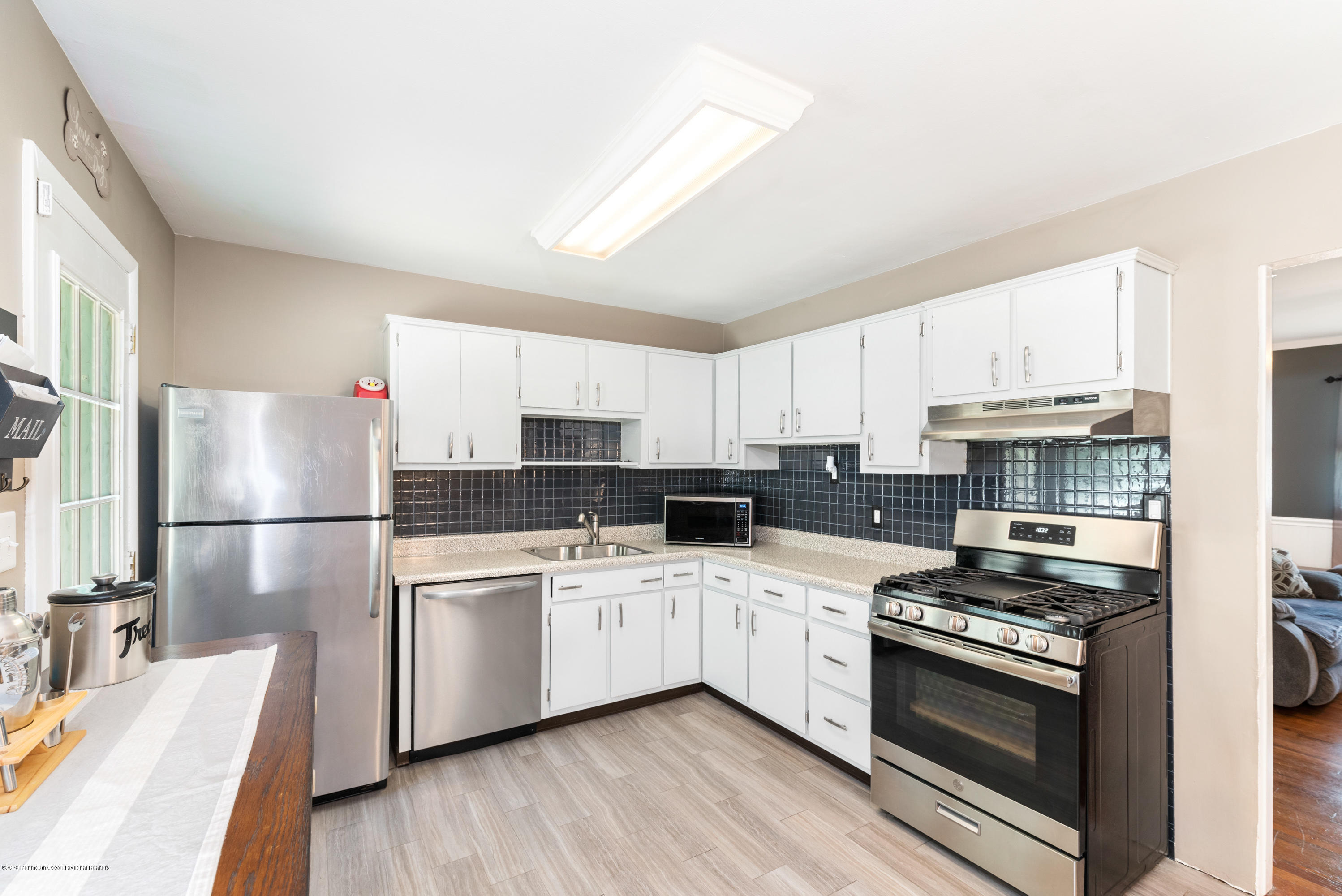 53 Salem Hill Road Howell, NJ 07731 - Photo 10 of 27 a kitchen with a sink white cabinets and stainless steel appliances