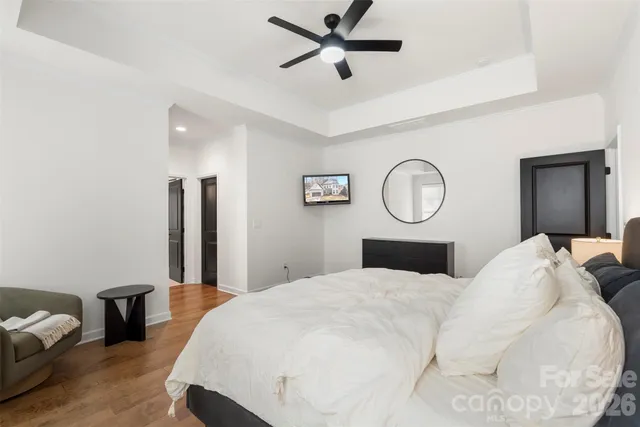 a view of a white house with a yard covered in snow