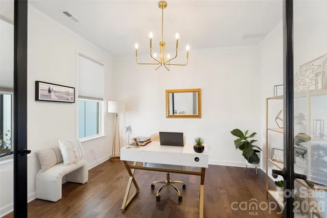 a living room with furniture a fireplace and a chandelier