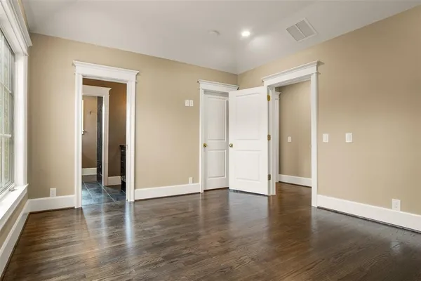 a bathroom with a granite countertop sink a toilet and a mirror